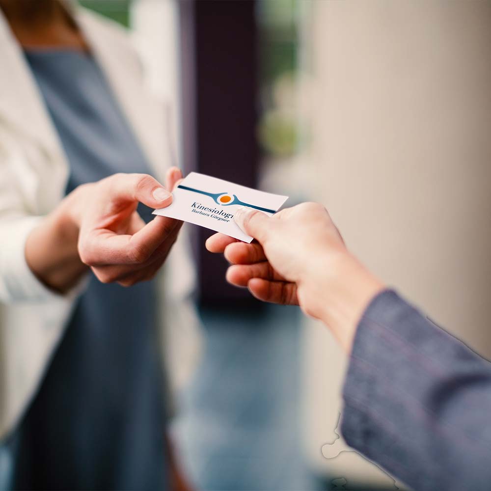 A man giving his businesscard to another person